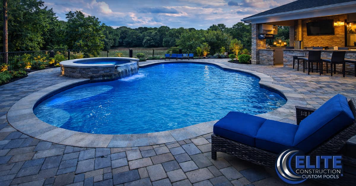 pool, pavers, representing inexpensive pool deck options by Elite Construction & Custom Pools